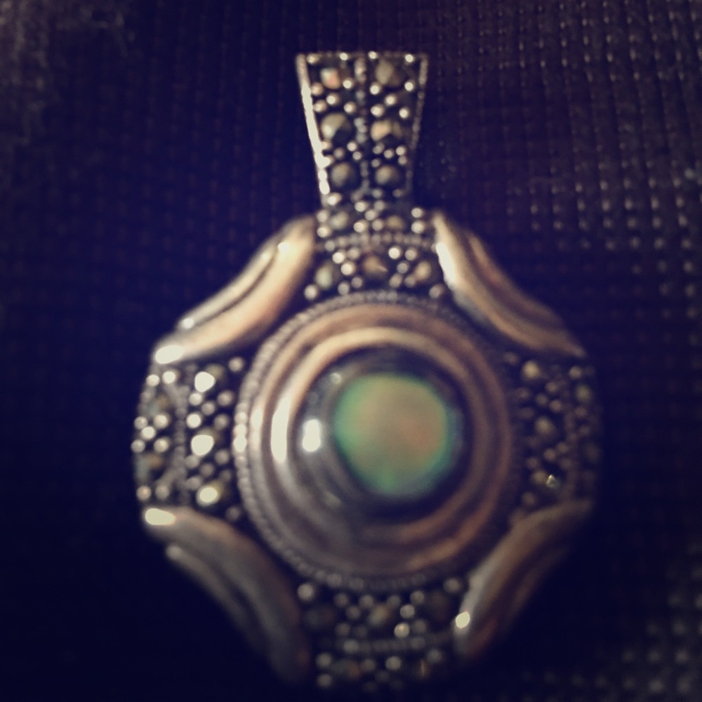 Silver brooch with green stone