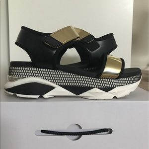ALDO Black and gold platform sneaker sandal.