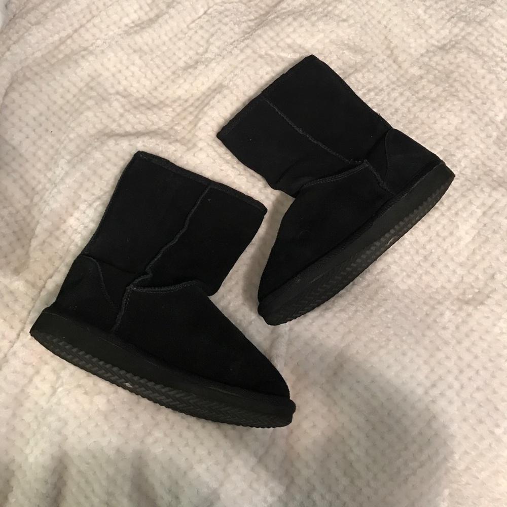 Black faux leather boots.