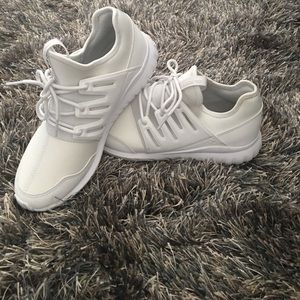All white Adiddas Tubulars