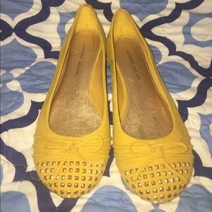 Mustard colored flats with gold accents