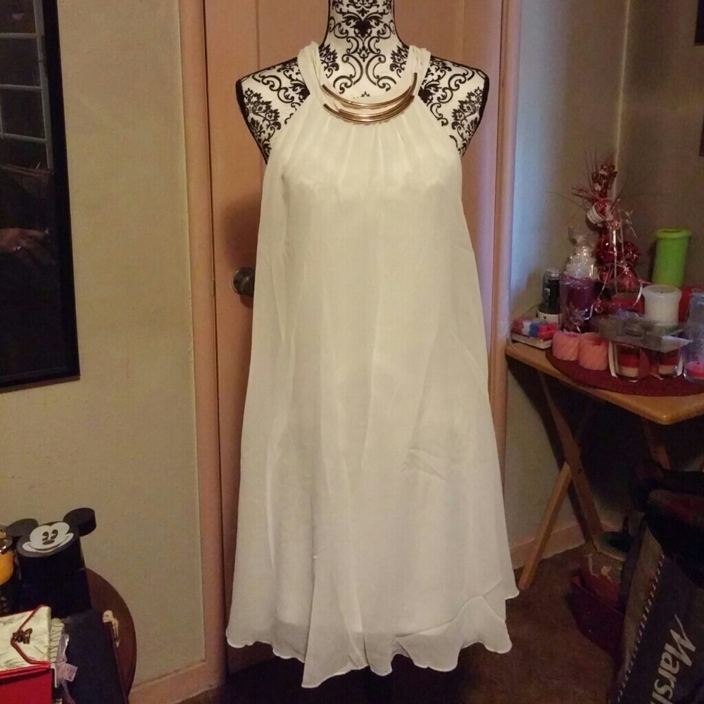 White dress trimmed with jewelry neckline