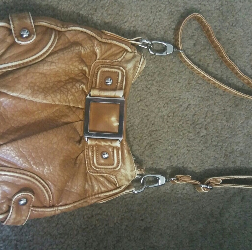 A brown leather black rivet purse