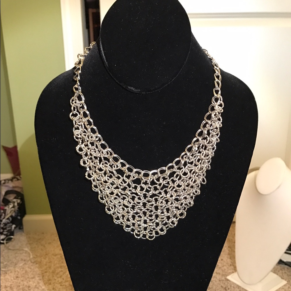 Silver toned bib necklace.