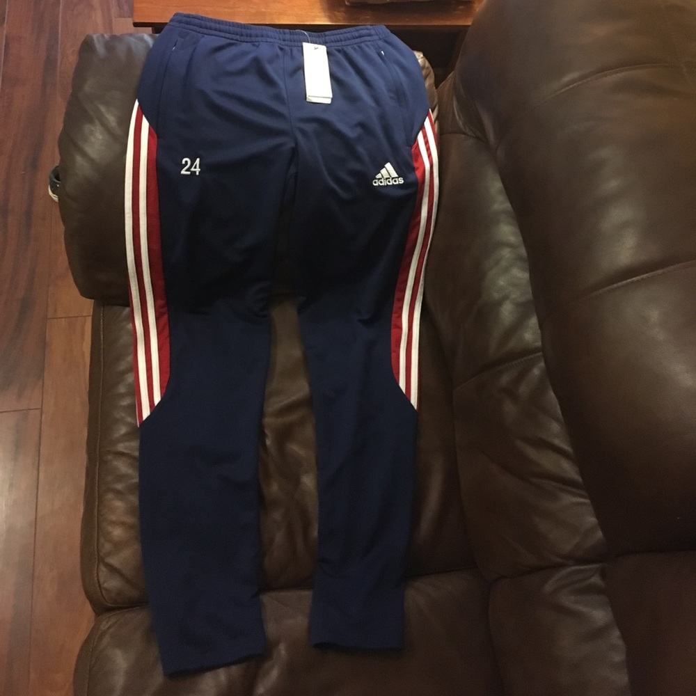 Adidas pants with zipper bottoms and pockets