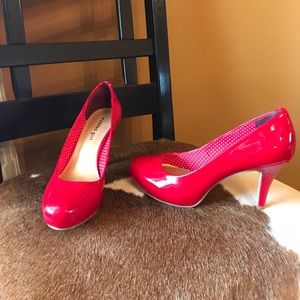 Red patent pumps