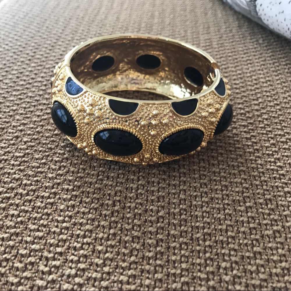 Gold toned bracelet with black cabochon stones