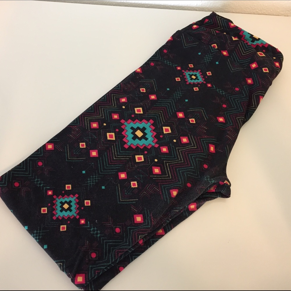 Black background with teal and pink Aztec print.