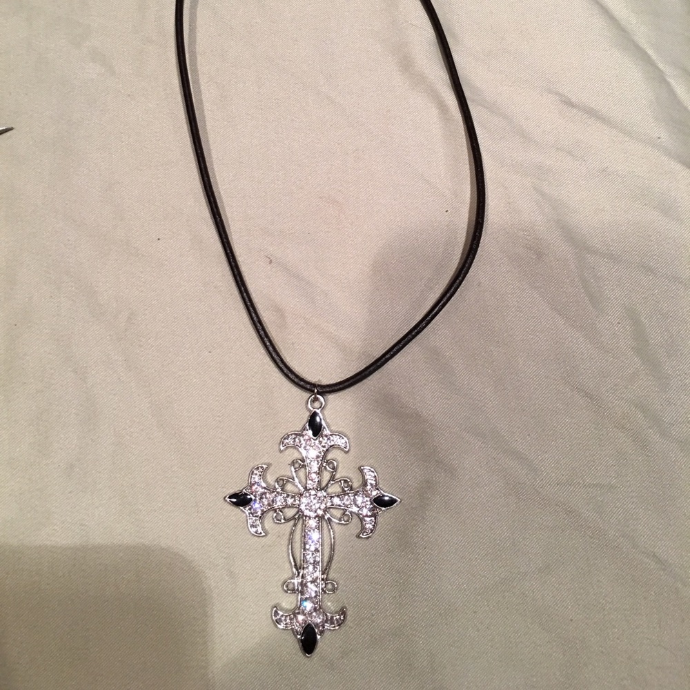 Beautiful cross bling pendant on blk leather cord