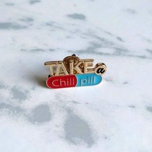 Take a chill pill enamel pin