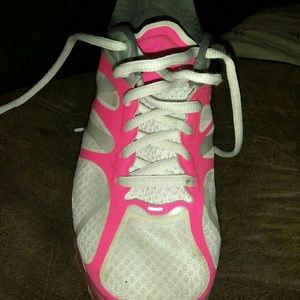 White and pink Nike athletic shoes