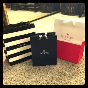 Shopping bags; Kate Spade, Sephora, and Swarovski.