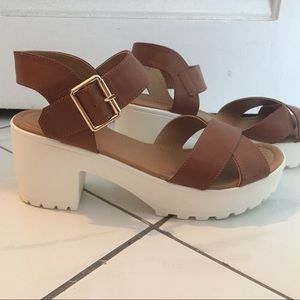 A pair of platform shoes with a small heel.