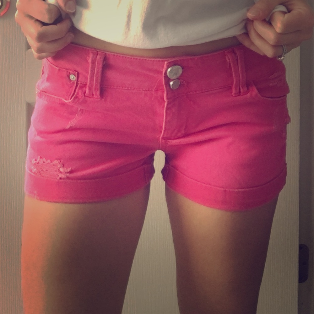 Hot pink distressed stretch denim cuffed shorts