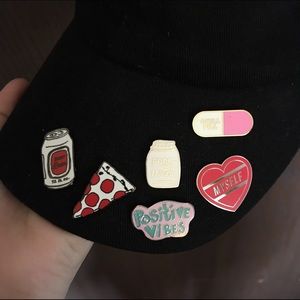 Black hat with enamel pins