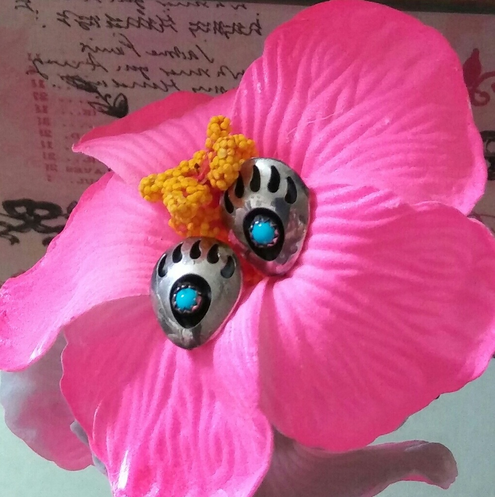 Adorable bear paw earrings with turquoise center.