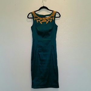 Knee length, form fitting teal cocktail dress