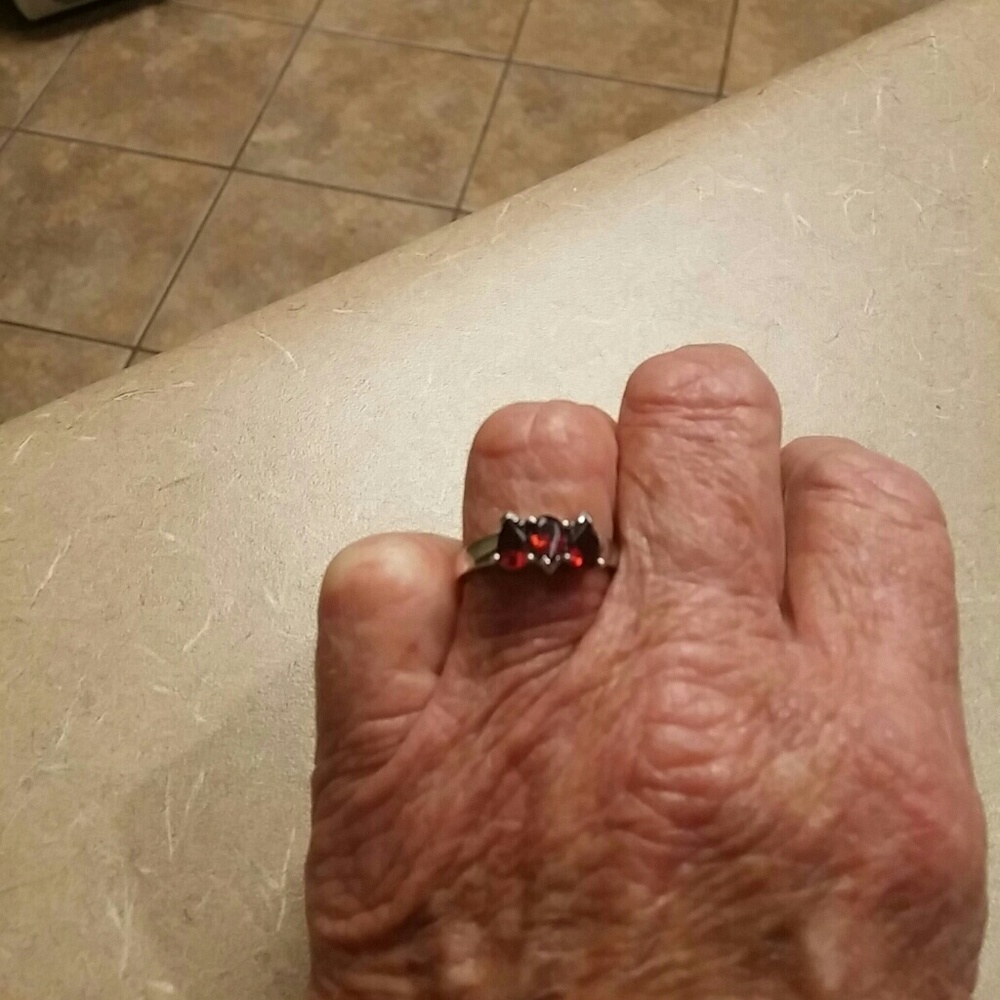 Size 8 silver ring with garnet stones.