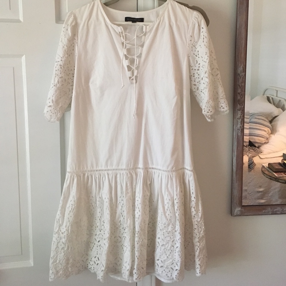 Drop-waist white dress with lace-up details