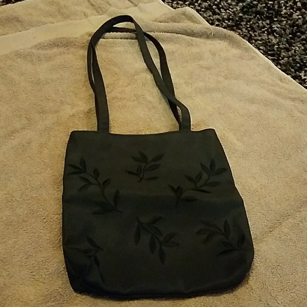 Black purse with embroidered leaf pattern