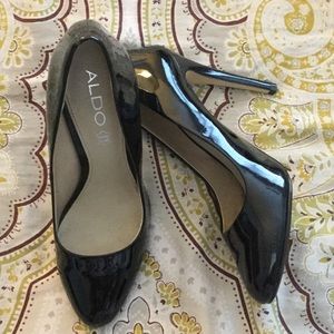 Black patent leather pumps.