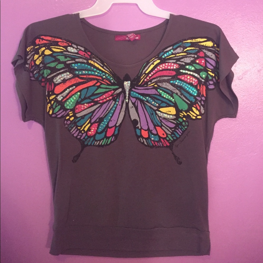 Cute t-shirt blouse with butterfly across chest.