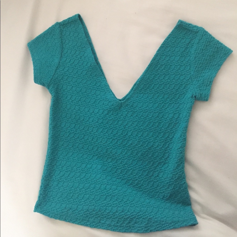 A teal, crop top discontinued from Wet Seal.