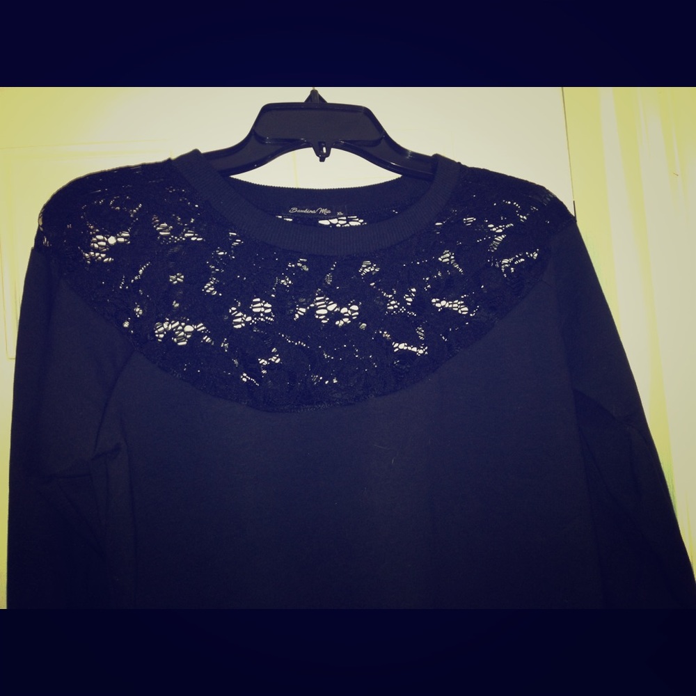 Black top with lace detail at the neck line.