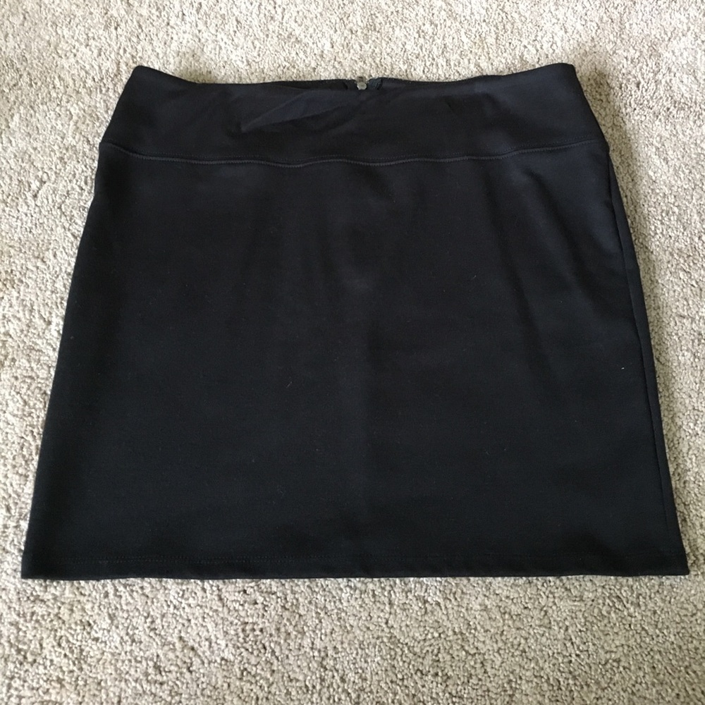 Black stretchy mini skirt.