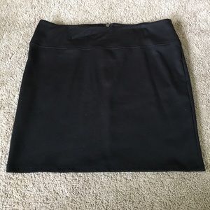 Black stretchy mini skirt.
