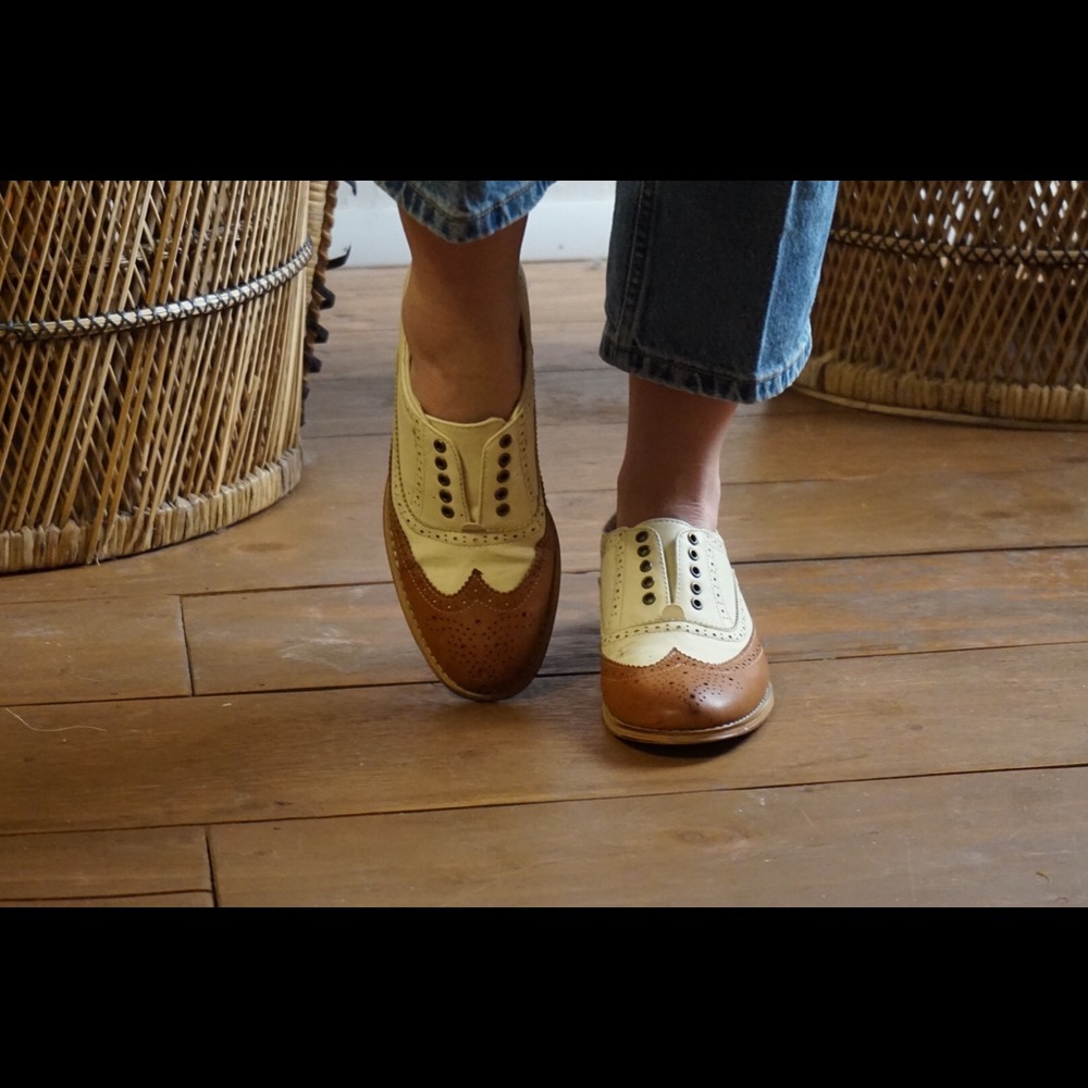 Brown and white Oxford flats
