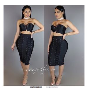 Black skirt two piece with ties down the middle.