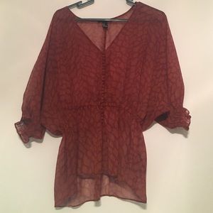 Patterned V-neck blouse.