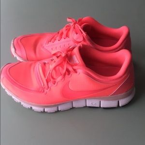 Bright pink Nike running shoes