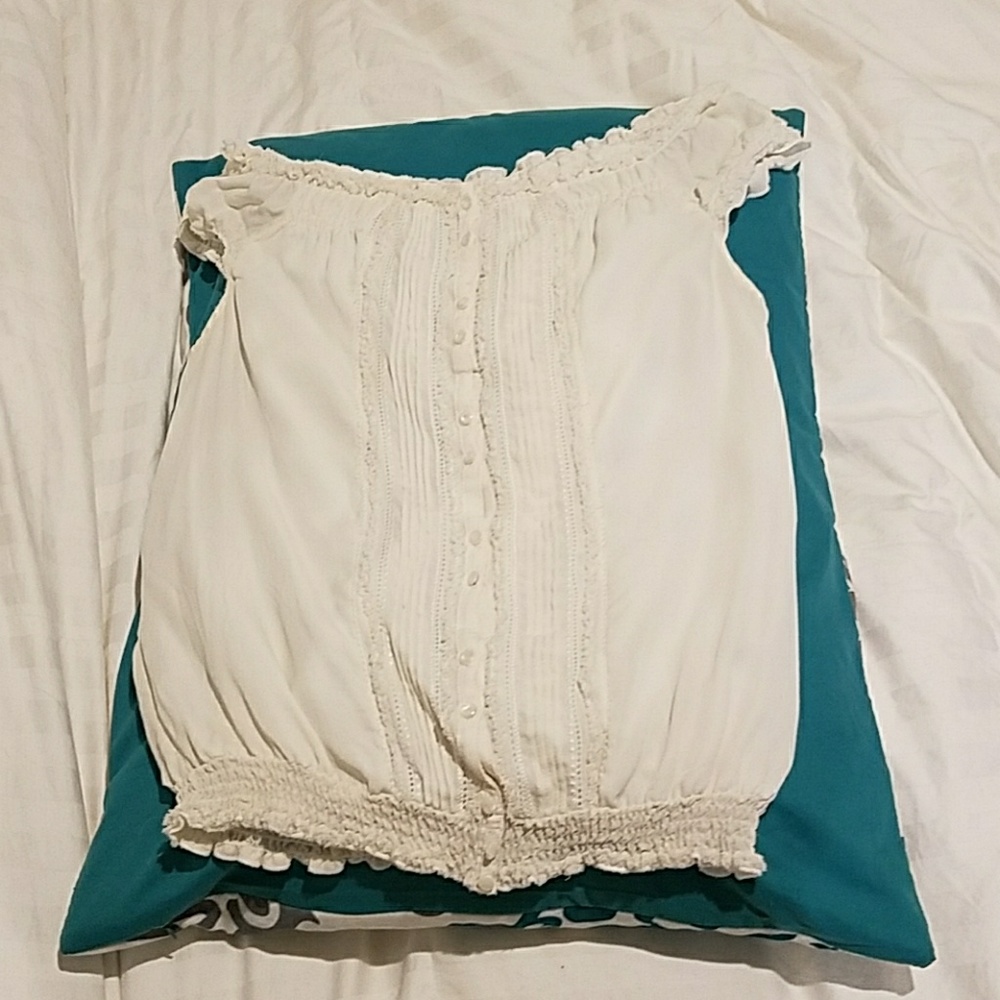 A button up tank top with designer ruffles
