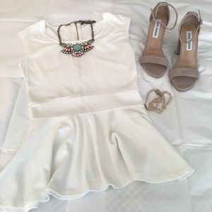 Ivory peplum top with lace back.