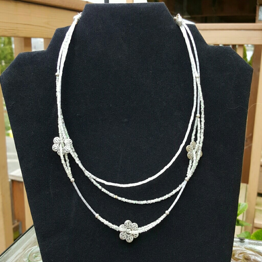Silver glass and flowers woven in this lovely neck