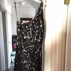 A black sequin, one shouldered prom dress by Scala