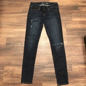 Distressed dark wash jeans