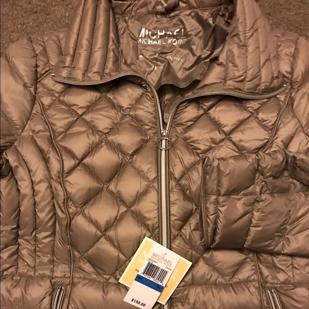 Light gray puffy MK jacket.