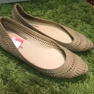 Tan suede flats with cutouts and raised details