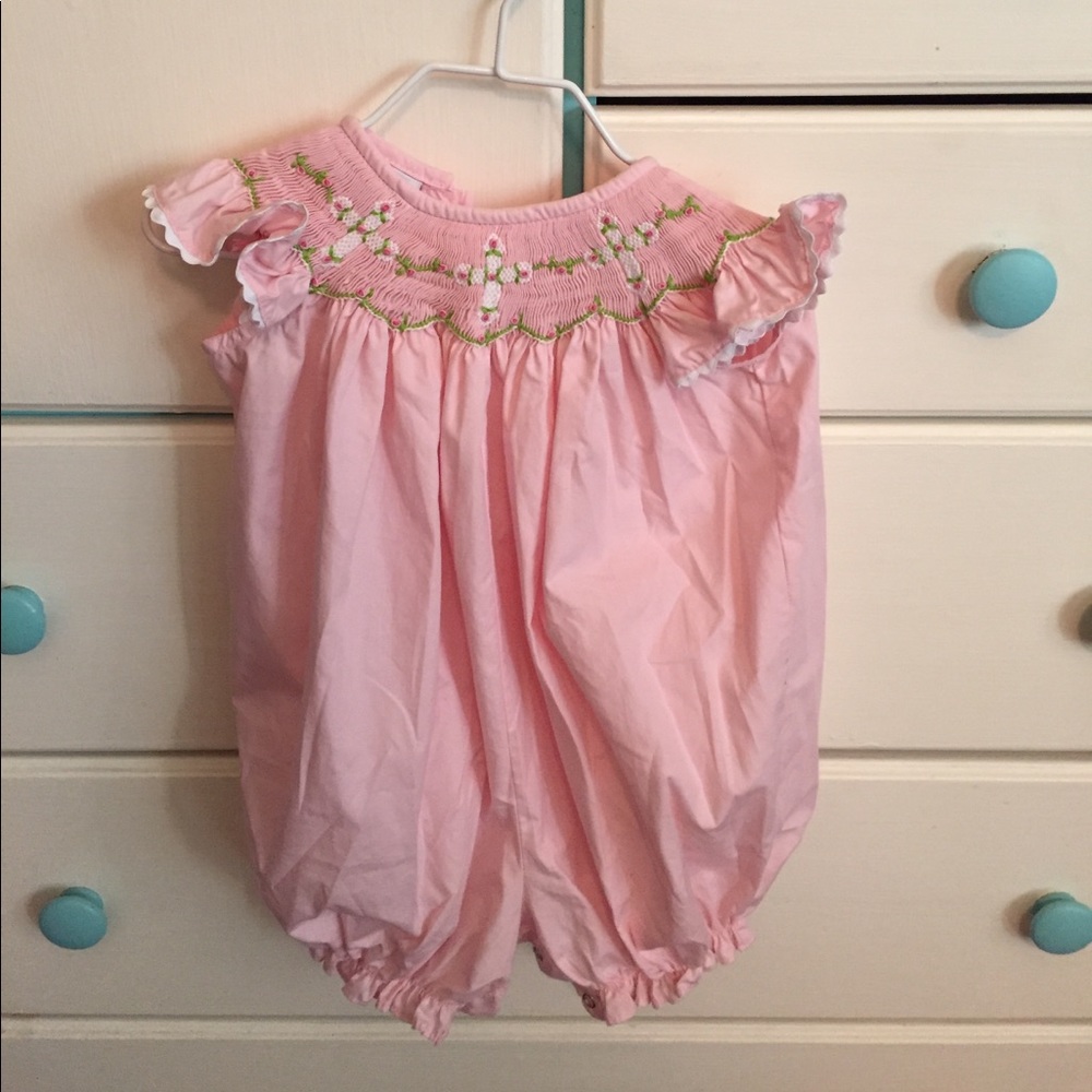 Baby onesie with crosses.