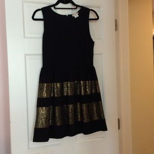 Black dress with gold detailing on bottom