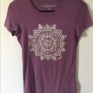 Purple form fitting t-shirt.