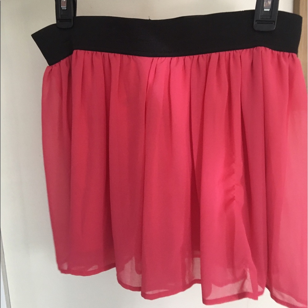 Short, flowy pink skirt