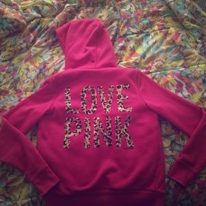 Pink hoodie with leopard sequence on back.