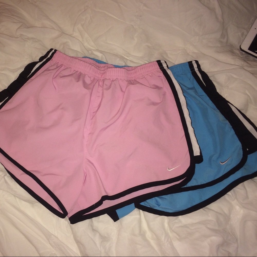 two nike running shorts (baby pink and light blue)