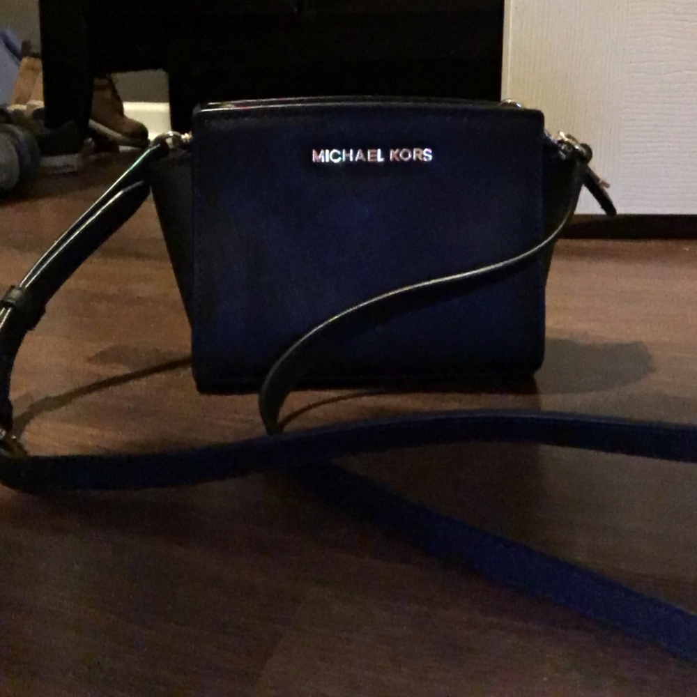 Black and gold over the shoulder Michael kors bag