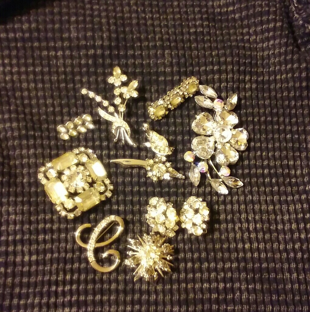 Rhinestone and plastic silver colored brooches