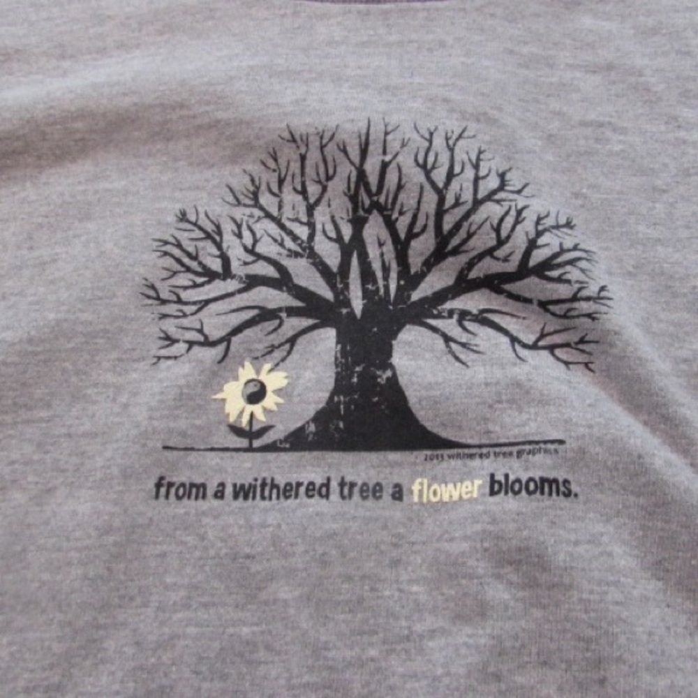"From a withered tree a flower blooms"